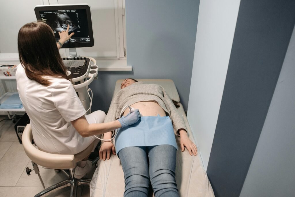 Healthcare professional performing an ultrasound scan on a patient in a medical clinic.