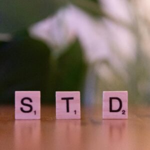 Scrabble tiles spelling 'STD' symbolize sexually transmitted diseases awareness and prevention.