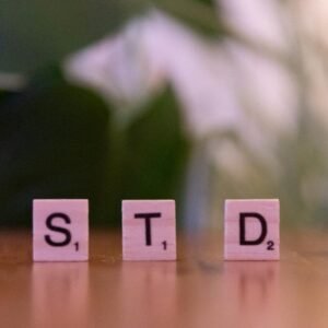 Scrabble tiles spelling 'STD' symbolize sexually transmitted diseases awareness and prevention.