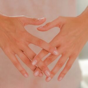 persons hand on white textile